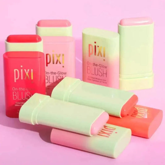 Pixi Blush Stick multi-functional cream for cheek, eye, and lip with various shades on pink background.